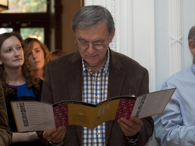 A photo of a man reading a pamphlet 