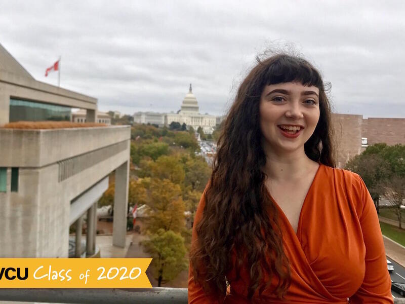 A student standing on the outdoor patio of the Newseum.