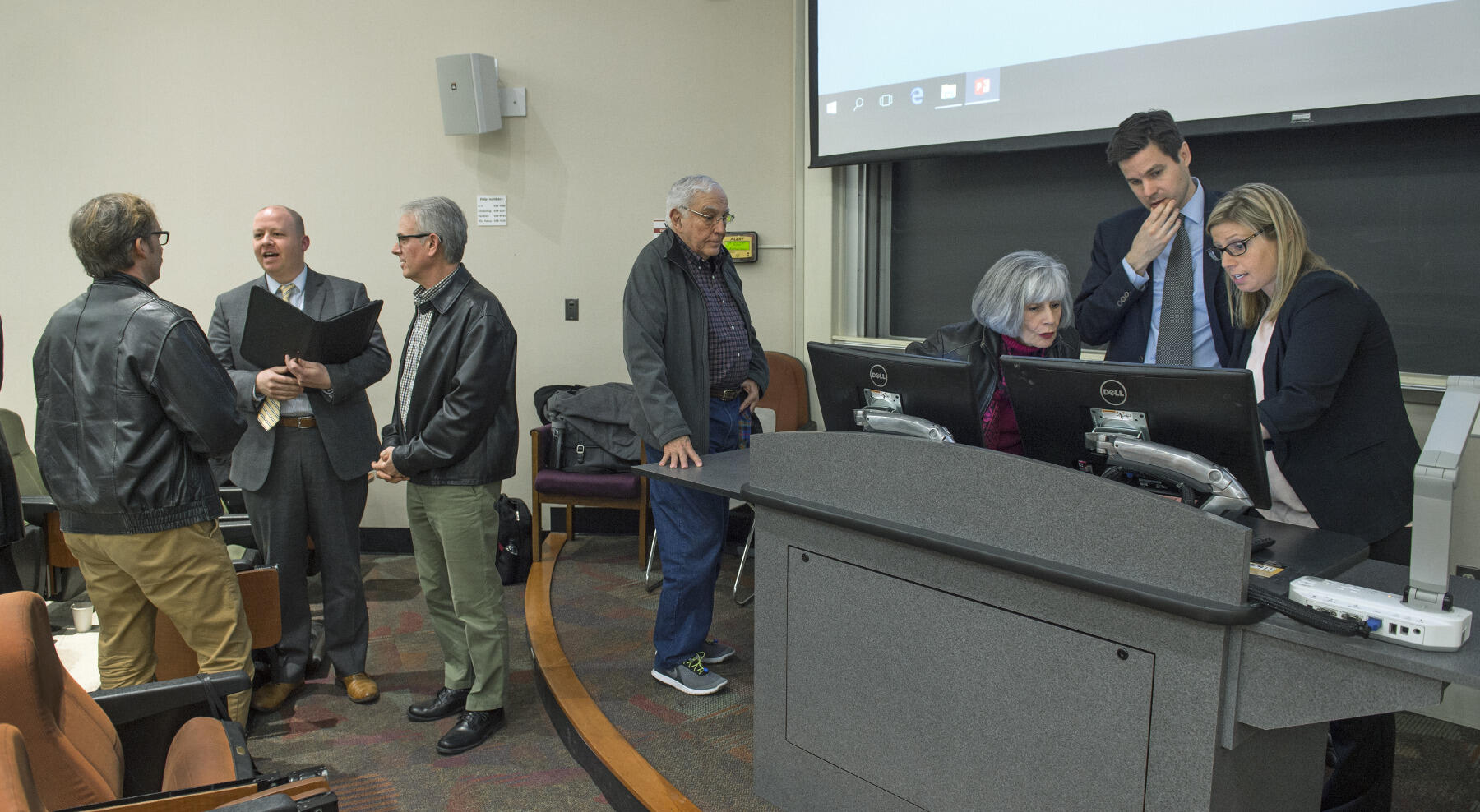 The planning team remains after a session to answer questions and receive feedback from audience members.