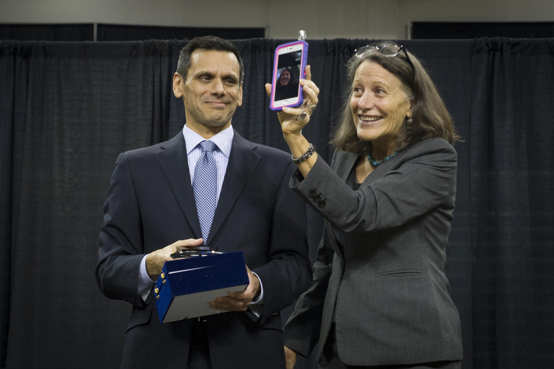 Dr. Rao presents the President’s Outstanding Achievement Award to Kathryn Murphy-Judy, accepting on behalf of Lisa Yamin. Yamin was in Atlanta to receive the National Advising Certificate of Merit Award, but joined the ceremony via video chat.