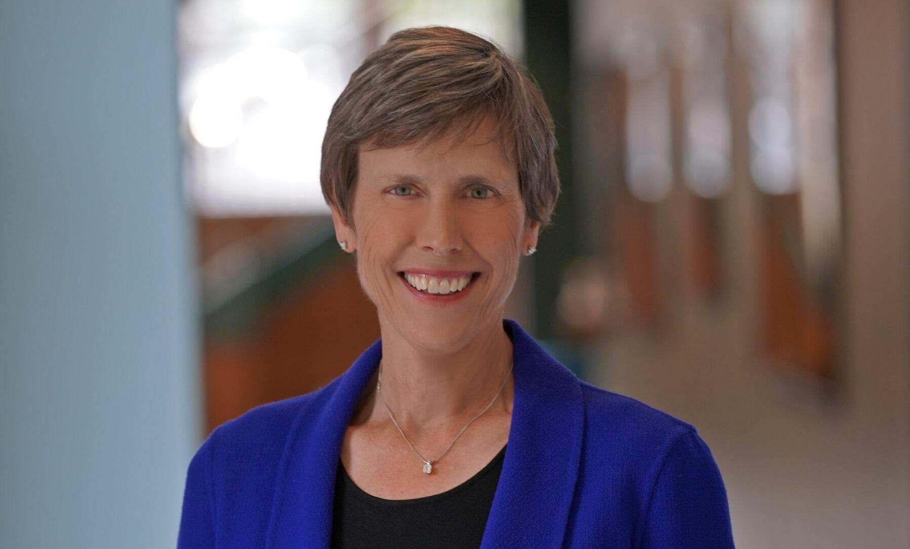 A photo of a woman standing in a hallway