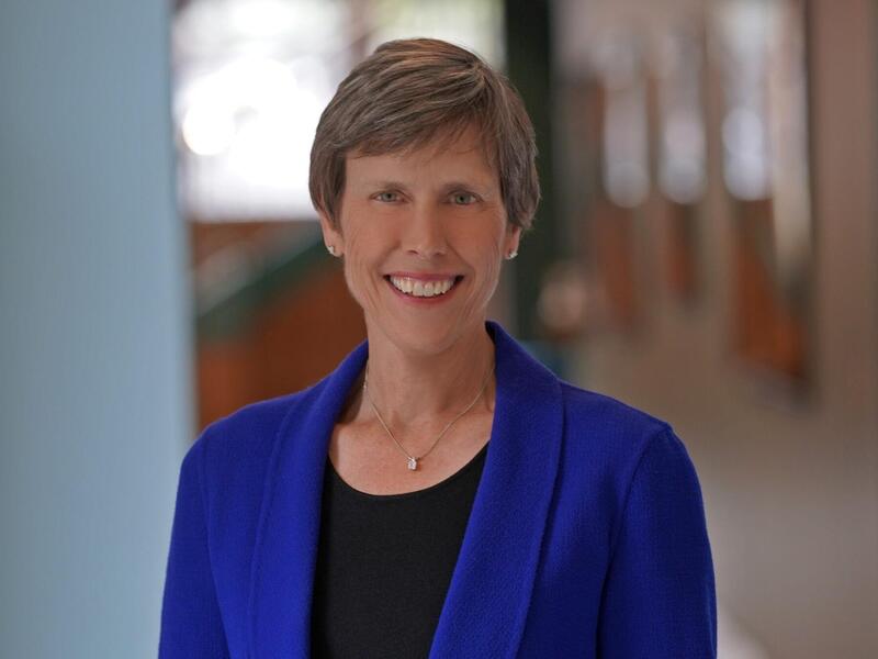 A photo of a woman standing in a hallway