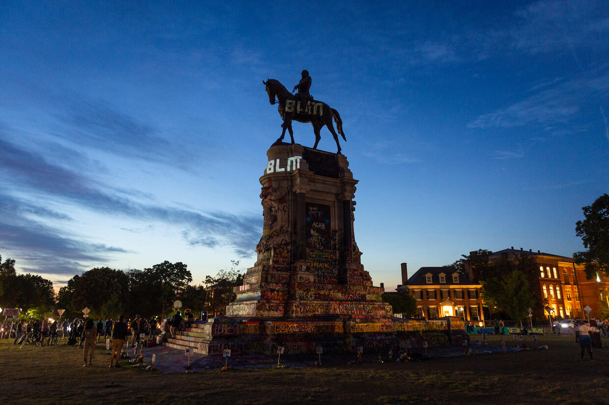 Lee Monument in Richmond with the letters \"B\" \"L\" and \"M\" projected onto it.