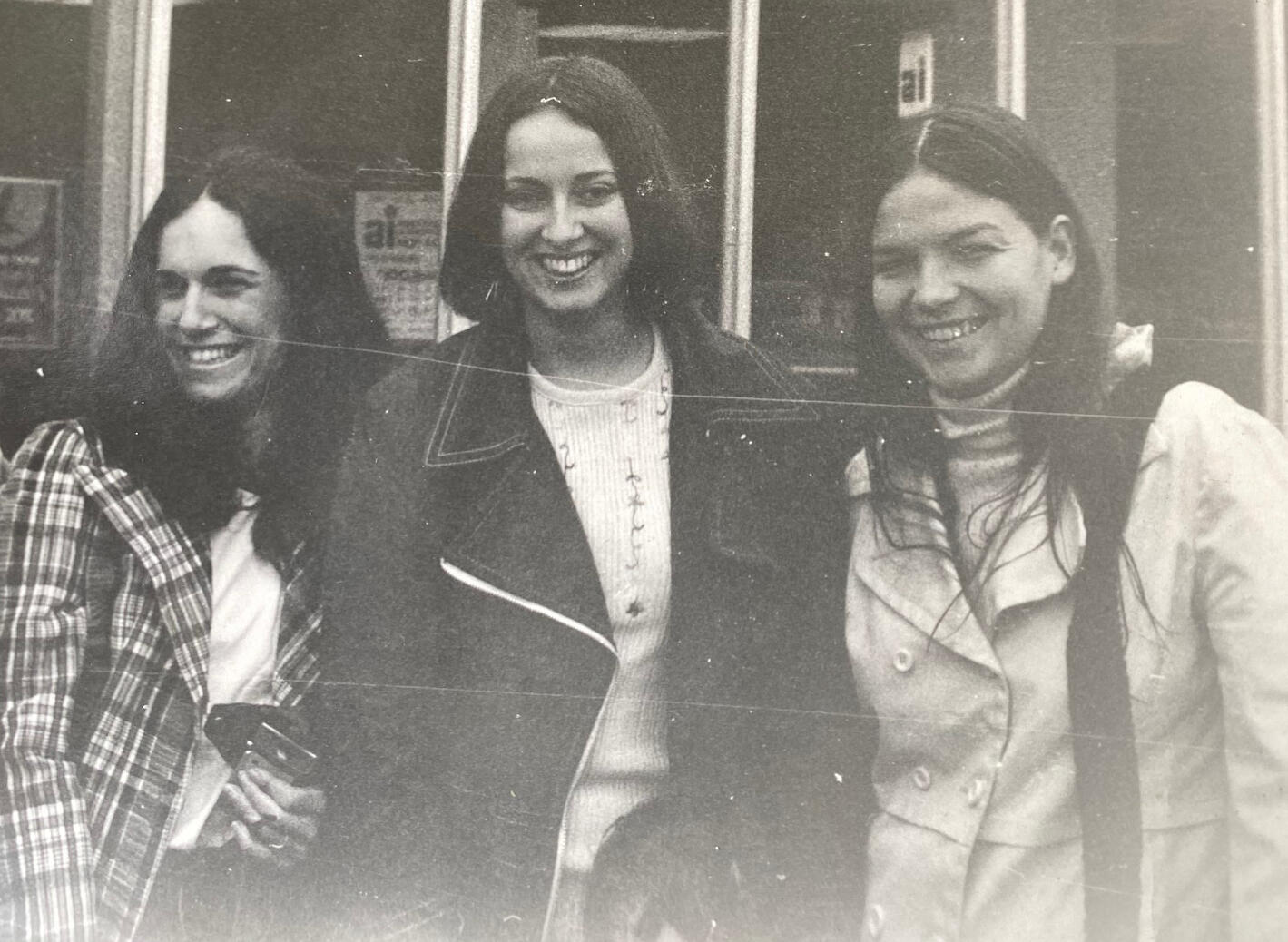 A black and white photo of three women 