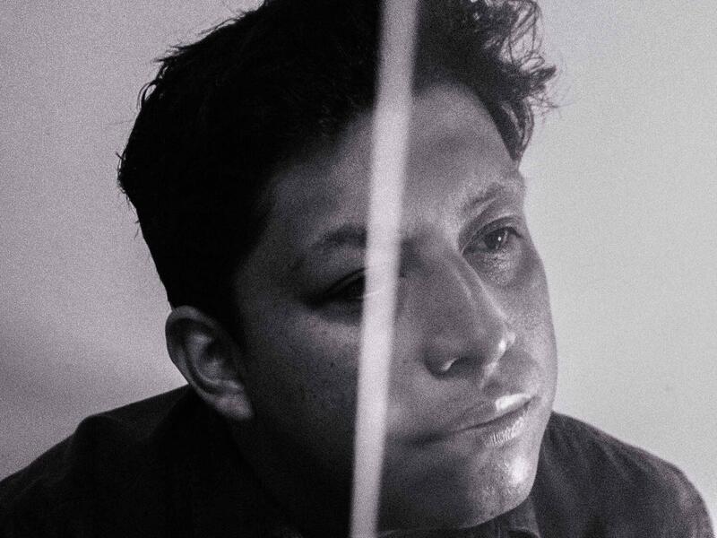 A photo of a man from the shoulders up. 