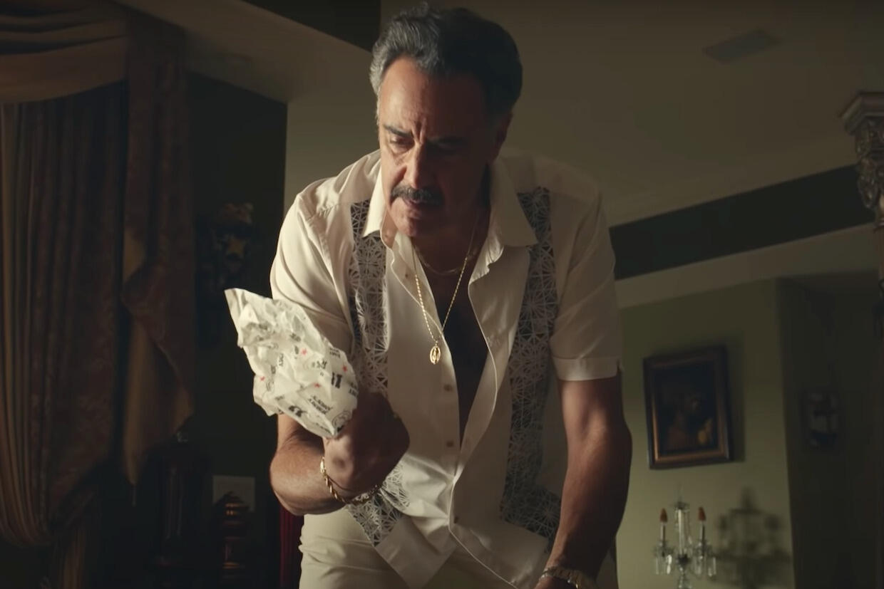 actor Brad Garrett standing over a sandwich wrapper in an advertisement for Jimmy John's sandwiches 