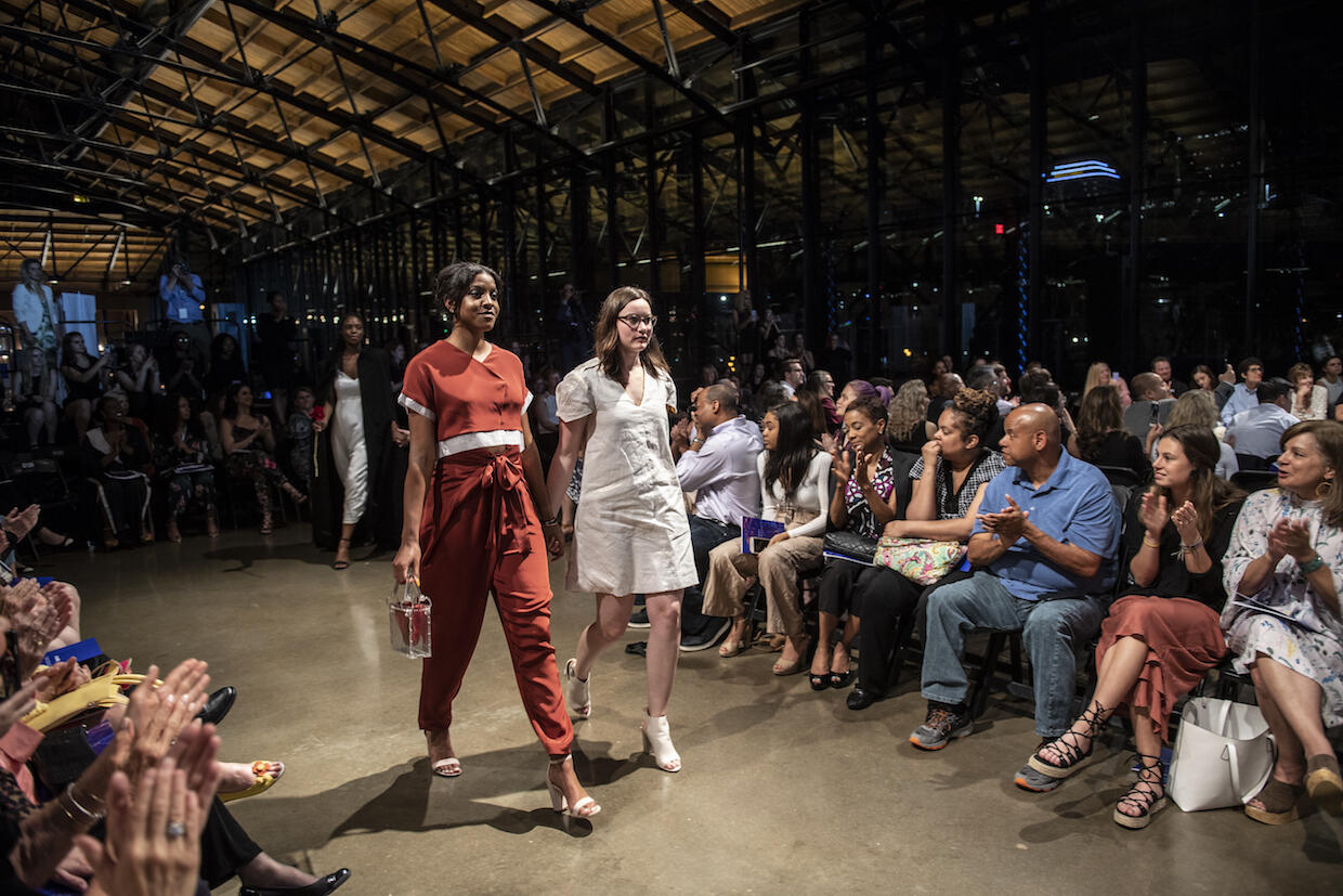 Designer Anna Carlson (right) walks down the runway with a model wearing her art deco-meets-mod wraparound pants. 