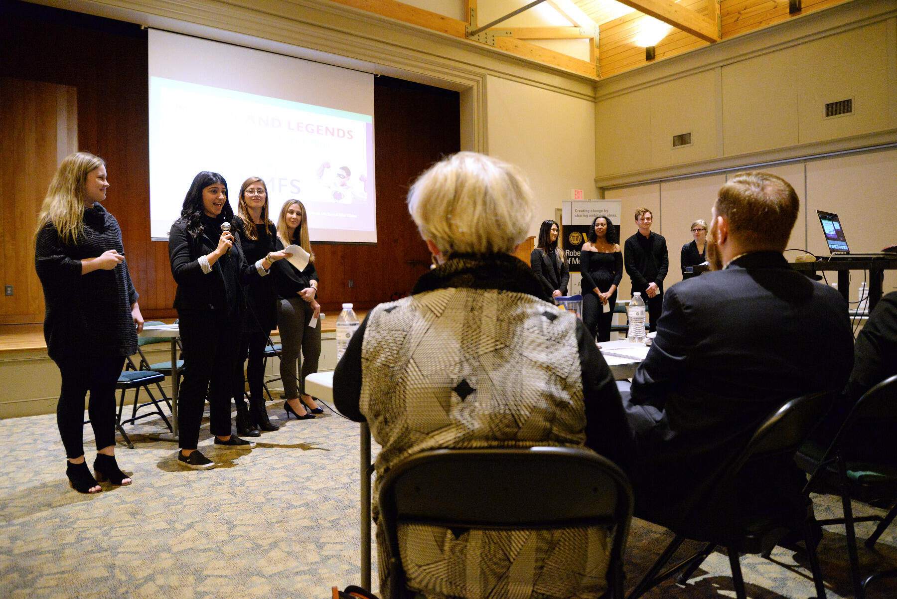 Lilia Souri, a senior PR major, discusses her team's pamphlet designed for UMFS that responds to common misconceptions about being a foster parent.