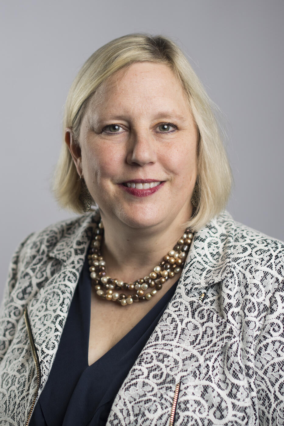 Head and shoulders portrait of person with blonde hair.