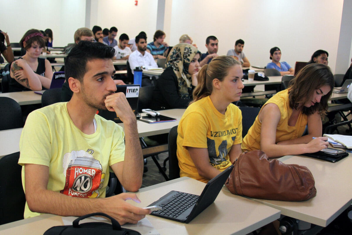 Students from Iraq and Virginia Commonwealth University listen as Social Media Institute co-director and associate professor Marcus Messner, Ph.D., delivers a lecture. 